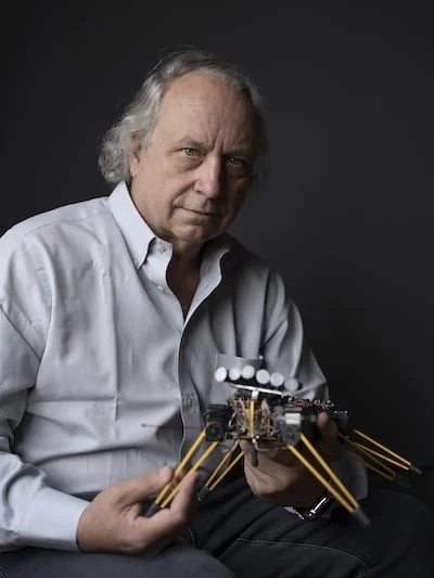 Rodney Brooks: The Mind Behind Modern Robotics and AI - Brooks in September 2021<a href="https://people.csail.mit.edu/brooks/all%20images/company%20images/brooks_sept_2021.jpg" rel="nofollow"> Source</a>